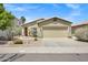 Charming single-story home with a well-manicured front yard and two car garage at 110 E Saddle Way, San Tan Valley, AZ 85143