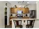 Kitchen featuring dark appliances, light counter tops and convenient bar seating at 110 E Saddle Way, San Tan Valley, AZ 85143