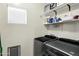 Functional laundry room with modern appliances and shelving for storage at 110 E Saddle Way, San Tan Valley, AZ 85143