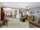 Cozy living room with carpet, ceiling fan, and views into the dining and kitchen areas at 110 E Saddle Way, San Tan Valley, AZ 85143