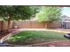 Lush backyard featuring mature trees, a swing set, and ample green space, perfect for outdoor enjoyment and play at 11746 W Camino Vivaz --, Sun City, AZ 85373