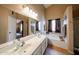 Well-lit bathroom features double sinks, soaking tub, and neutral tones throughout at 11746 W Camino Vivaz --, Sun City, AZ 85373