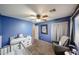 Blue bedroom featuring a ceiling fan, carpet flooring, and furnishings at 11746 W Camino Vivaz --, Sun City, AZ 85373
