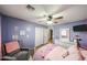 Comfortable bedroom with mauve walls, plush furnishings, and plenty of natural light at 11746 W Camino Vivaz --, Sun City, AZ 85373
