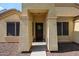 Inviting front entry with decorative wreath and sheltered porch leading into the home at 11746 W Camino Vivaz --, Sun City, AZ 85373