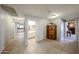 Hallway with views of kitchen and bath, tile flooring, and wood cabinetry at 11746 W Camino Vivaz --, Sun City, AZ 85373