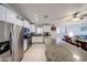 Bright kitchen featuring granite countertops, stainless steel appliances, and ample cabinet space at 11746 W Camino Vivaz --, Sun City, AZ 85373