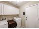 Efficient laundry room featuring white cabinets, washer and dryer hookups and door to exterior at 11746 W Camino Vivaz --, Sun City, AZ 85373
