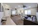Comfortable living area featuring tile and carpet flooring, windows, and ceiling fan at 11746 W Camino Vivaz --, Sun City, AZ 85373