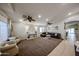 Spacious living room with plush carpeting, ceiling fans, and abundant natural light at 11746 W Camino Vivaz --, Sun City, AZ 85373