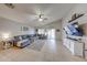 Stylish living room with vaulted ceilings, tile floors, and a sliding glass door to the outdoor space at 11746 W Camino Vivaz --, Sun City, AZ 85373