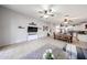 Open-concept living room featuring tile flooring, modern decor, and seamless flow to kitchen area at 11746 W Camino Vivaz --, Sun City, AZ 85373