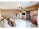 Cozy main bedroom featuring plush carpet, decorative sliding barn door, and accent wall at 11746 W Camino Vivaz --, Sun City, AZ 85373