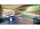 Inviting covered patio with comfortable seating and an outdoor grill overlooking a well-maintained backyard at 11746 W Camino Vivaz --, Sun City, AZ 85373