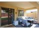 Covered patio with cozy seating, a fire pit, and a mini fridge, ideal for outdoor entertaining and relaxation at 11746 W Camino Vivaz --, Sun City, AZ 85373