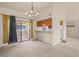 Open dining area with sliding glass doors to the patio and a passthrough to the kitchen at 1402 E Guadalupe Rd # 215, Tempe, AZ 85283