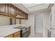 Functional kitchen with white countertops, vintage appliances and wood cabinetry at 1402 E Guadalupe Rd # 215, Tempe, AZ 85283