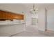 Bright living room featuring neutral carpet, a chandelier, and an opening to the kitchen at 1402 E Guadalupe Rd # 215, Tempe, AZ 85283