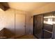 A covered patio with concrete floor, sliding glass door, and door to a storage closet at 1402 E Guadalupe Rd # 215, Tempe, AZ 85283