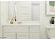 Clean bathroom features a vanity with sink, mirror, and toilet at 14930 W Buckskin Trl, Surprise, AZ 85387
