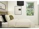 Cozy bedroom with large window, plush pillows, and modern decor at 14930 W Buckskin Trl, Surprise, AZ 85387