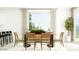 Bright dining area with a modern table, chairs, stylish buffet, and lots of light at 14930 W Buckskin Trl, Surprise, AZ 85387
