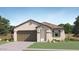 Charming single-story home with a stucco exterior, tile roof, and a two-car garage at 14930 W Buckskin Trl, Surprise, AZ 85387