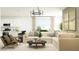 Open living area with a modern kitchen, comfortable seating, and elegant decor at 14930 W Buckskin Trl, Surprise, AZ 85387