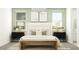 Inviting main bedroom with a decorative bed, matching nightstands, and a bench at 14930 W Buckskin Trl, Surprise, AZ 85387