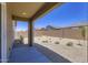 View of a low-maintenance backyard and covered patio with gravel and desert landscaping at 15018 W Buckskin Trl, Surprise, AZ 85387
