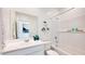 Modern bathroom with a large mirror, white subway tile, and stylish decor, offering a clean and relaxing space at 15018 W Buckskin Trl, Surprise, AZ 85387