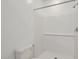 Bright bathroom with white walls, white tiled shower, and a toilet at 15018 W Buckskin Trl, Surprise, AZ 85387