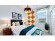 Comfortable bedroom with a decorative accent wall, stylish decor, and soft lighting for a restful atmosphere at 15018 W Buckskin Trl, Surprise, AZ 85387