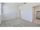 Bright bedroom with carpet, white walls, closet, and white doors at 15018 W Buckskin Trl, Surprise, AZ 85387
