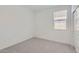 Clean, bright bedroom with neutral carpet and a window providing ample natural light at 15018 W Buckskin Trl, Surprise, AZ 85387