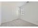 A bedroom with neutral carpet features sliding closet doors and a window at 15018 W Buckskin Trl, Surprise, AZ 85387