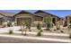 Charming single-story home featuring a two-car garage, desert landscaping, and a welcoming entryway at 15018 W Buckskin Trl, Surprise, AZ 85387