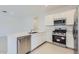 Modern kitchen with stainless steel appliances, white cabinets, and a sleek countertop at 15018 W Buckskin Trl, Surprise, AZ 85387
