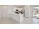 Bright kitchen with stainless steel appliances, white cabinets, and a breakfast bar at 15018 W Buckskin Trl, Surprise, AZ 85387
