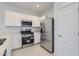 Modern kitchen equipped with stainless steel appliances, white cabinets, and ample counter space at 15018 W Buckskin Trl, Surprise, AZ 85387