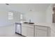 Clean and modern kitchen featuring a stainless steel dishwasher and a large sink at 15018 W Buckskin Trl, Surprise, AZ 85387