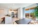 Bright kitchen featuring modern appliances, white cabinets, and a dining area with a sliding glass door at 15018 W Buckskin Trl, Surprise, AZ 85387