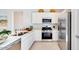 Modern kitchen featuring stainless steel appliances, white cabinets, and a sleek countertop at 15018 W Buckskin Trl, Surprise, AZ 85387