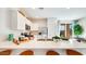 Bright, open kitchen features white cabinets, stainless steel appliances, and a large center island with bar seating at 15018 W Buckskin Trl, Surprise, AZ 85387