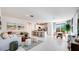 Spacious open-concept layout with a living area, kitchen island, and dining space bathed in natural light at 15018 W Buckskin Trl, Surprise, AZ 85387