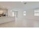 Bright living space with white walls, tiled floor, and stainless steel kitchen appliances at 15018 W Buckskin Trl, Surprise, AZ 85387