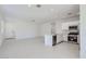 Open floor plan featuring a modern kitchen and spacious living area with neutral tile floors at 15018 W Buckskin Trl, Surprise, AZ 85387