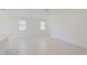 Spacious living area with bright lighting, tiled floors and large windows at 15018 W Buckskin Trl, Surprise, AZ 85387