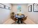 Cozy dining area with a round table, leather chairs, and natural light from a window at 15060 W Hackamore Dr, Surprise, AZ 85387