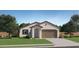 Charming single-story home featuring a neutral color scheme, a tile roof, and a two-car garage at 15060 W Hackamore Dr, Surprise, AZ 85387
